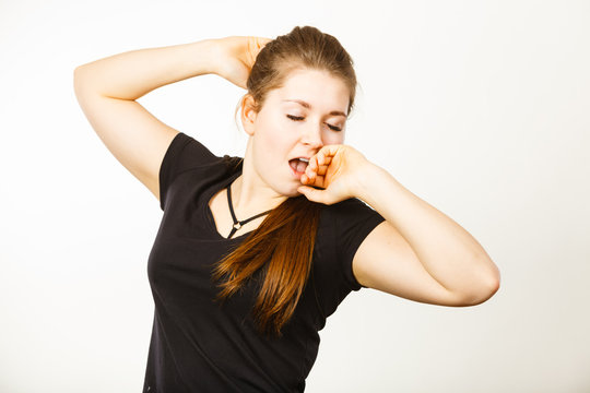 Young tired woman yawning