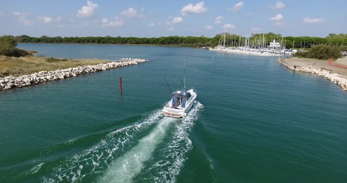 Italy coast of Eraclea sea view from the top of the boat comes into the bay with yachts