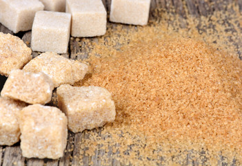 Beige raw sugar with cubes and crystal sugar on table