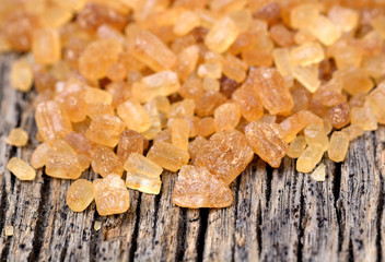 Many sugar brown candy crystals on table