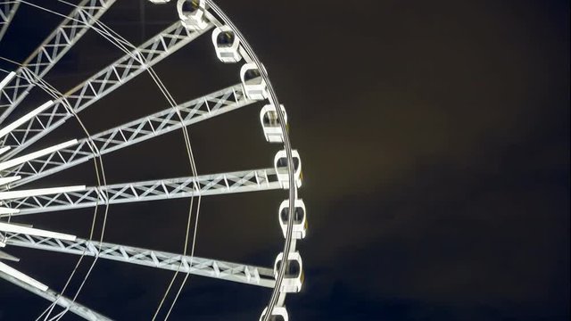 4K resolution time lapse, Close up to part of giant Ferris wheel at night, Fun park background.