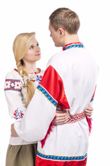 Portrait of Loving Embraced Caucasian Couple in National Belarussian and Russian Decorated Costumes. Against White Background.