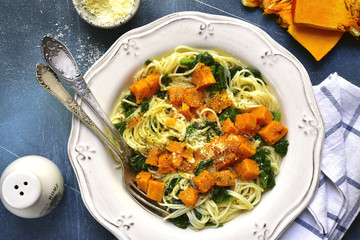 Spaghetti with roasted pumpkin and spinach.Top view.