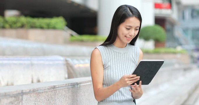 Business woman using tablet computer at outdoor