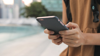 Woman using cellphone in the park