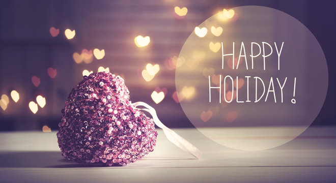 Happy Holiday message with a pink heart with heart shaped lights