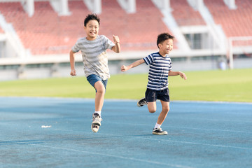 Boy running on the blue track