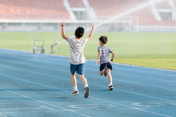 Boy running on the blue track