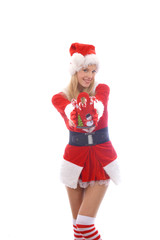 A young girl shows her happy feelings at Christmas time  as a candy cane presenter . Cheerfully she stands in front  of a white background and amuses herself with presenting Christmas candy canes.