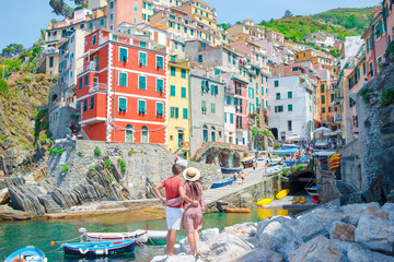 Young family with great view at old village Riomaggiore, Cinque Terre, Liguria, Italy. European...
