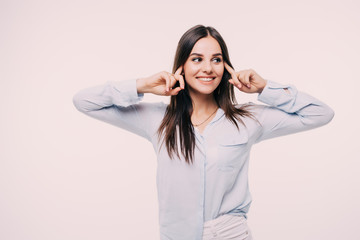 Girl plugs his ears with his hands. Fear of loud sounds and unpleasant loud noise on white