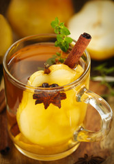 Pear punch with spices in glass cup