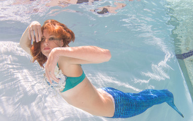 Woman with red hair in a swimming pool.