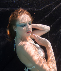 Woman with red hair in a swimming pool.