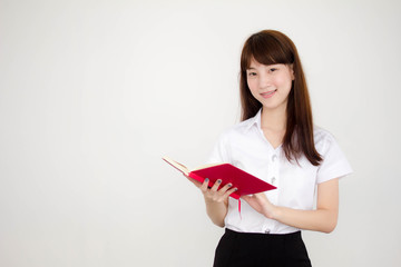 Portrait of thai adult student university uniform beautiful girl read red book