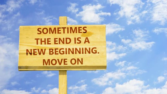 Sometimes the end is a new beginning, move on. Words on a wooden sign against time lapse clouds in the blue sky.