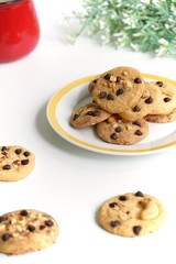 Homemade chocolate chip cookies and nut on a plate with white background