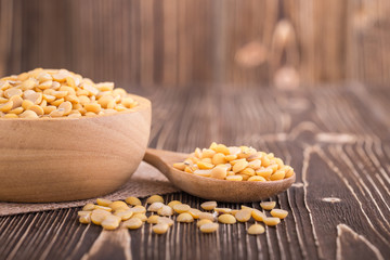 Peeled yellow soybean on brown wooden board