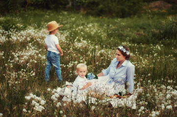 Fototapeta premium mother and two sons at the picnic .Happy family on summer vacation