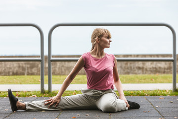 Active woman stretching warming up. Exercise.