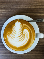 Closeup hot cappuccino on table with spoon