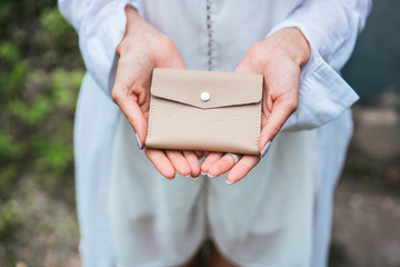 Woman hands hold purse