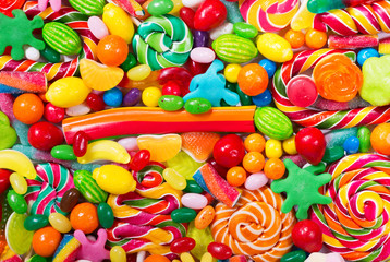 Fototapeta na wymiar Various colorful candies, jellies, lollipops and marmalade