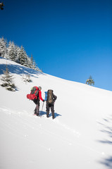 Two climbers are in the mountains.