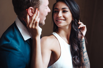 Beautiful, young couple posing on camera indoors