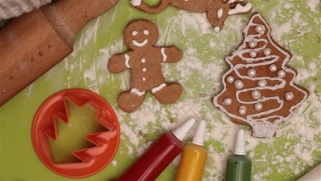Christmas cookies on the table - with all the utensils to make them, closeup, slow spin