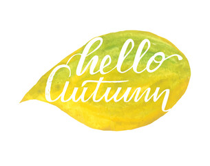 Hello autumn hand lettering phrase on yellow watercolor maple leaf background