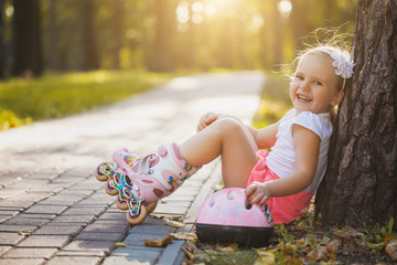 happy Little girl on roller skates at park