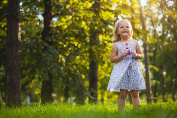 girl playing in the sunny summer park