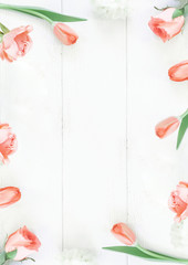 Pastel pink rose border on the white wooden table