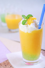 Juicy smoothie mango in glass mint leaf