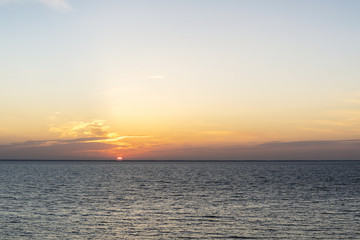 Sunrise behind the sea horizon