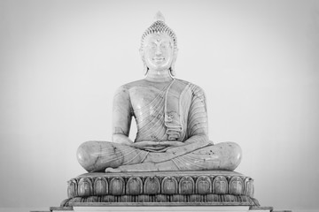 Fototapeta premium Marble buddha image on white background.Buddha statue in Buddhist temple or wat, is public domain or treasure of Buddhism. (Shot at outdoor ,public area)