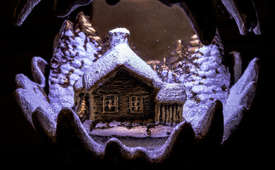 Obraz premium Handmade illuminated ceramics house and winter scene with Christmas trees