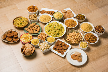 stock photo of  Diwali food or Diwali snacks or Diwali sweets like anarsa, bakarvadi, chakli, sev, bhujiya, shankar pale and chivda or chiwada, karanji, favourite indian diwali recipe, 
