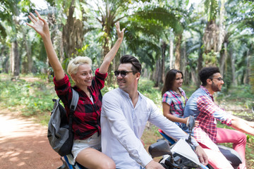 Happy Free Couples Driving Scooter Enjoy Travel In Tropical Forest Cheerful Friends Summer Road Trip Concept
