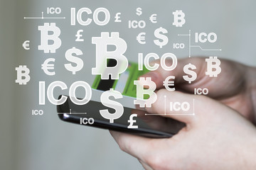 Businessman presses currencies button on phone ICO Initial Coin Offering on virtual digital electronic user interface account.