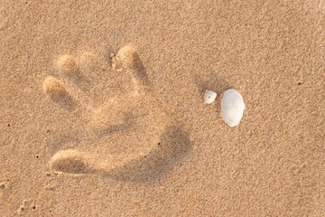 finger print in sand on the beach. Memories of the sea. Greetings from vacation. Evening on the beach.