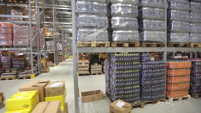 Shelves With Food in Distribution Warehouse From Moving Forklift
