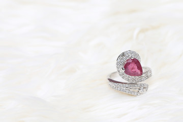 pink gemstone on diamond ring