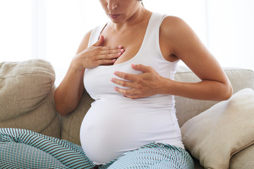 Pregnant woman having painful feelings in breast