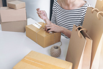 Internet online shopping concept, Young seller woman preparing package to be sent Mail transportation, service network connection market, technology on global, Order online for customer convenience