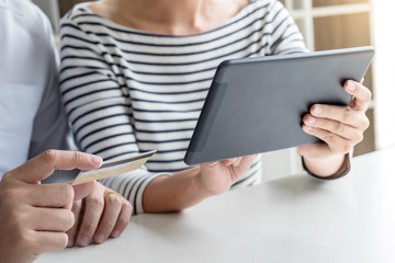 Two people using tablet and credit/debit card register payments online shopping and customer service network connection market, using technology on global, Internet Online shopping or banking concept