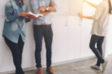 Blurred of Cheerful young student standing holding book and reading, classmates helps friend catching up workbook and learning tutoring lean on locker, teaching, learning, Education and school concept