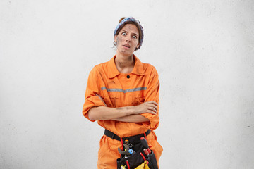 Portrait of discontent fatigue dirty female labour worker feels bored, does monotonous work all time, wants to have rest, looks tired and annoyed. Overworked woman does restoration or remodelling
