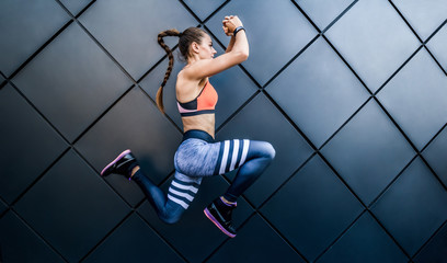 Full of energy and enthusiasm.Shot of a young woman  jumping outdoors.